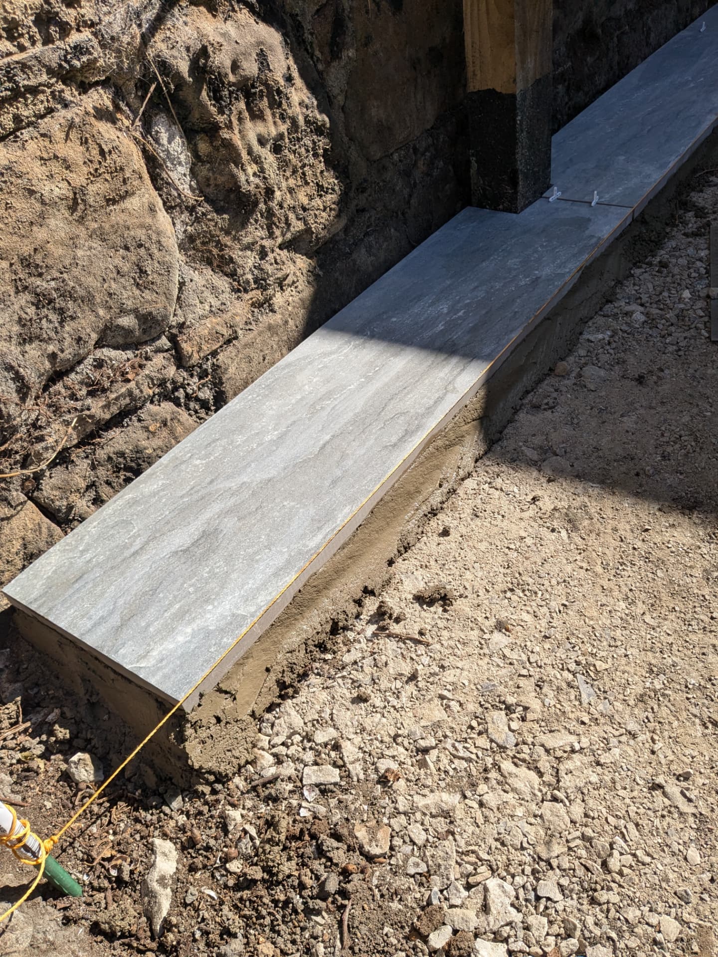 Garden patio — first run of slabs set on the concrete base