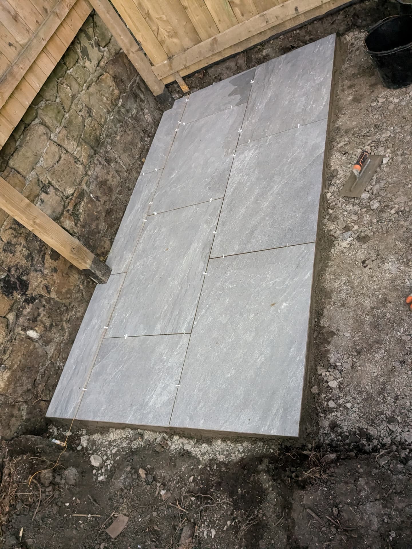 Garden patio — slabs bedded in and levelled along the wall