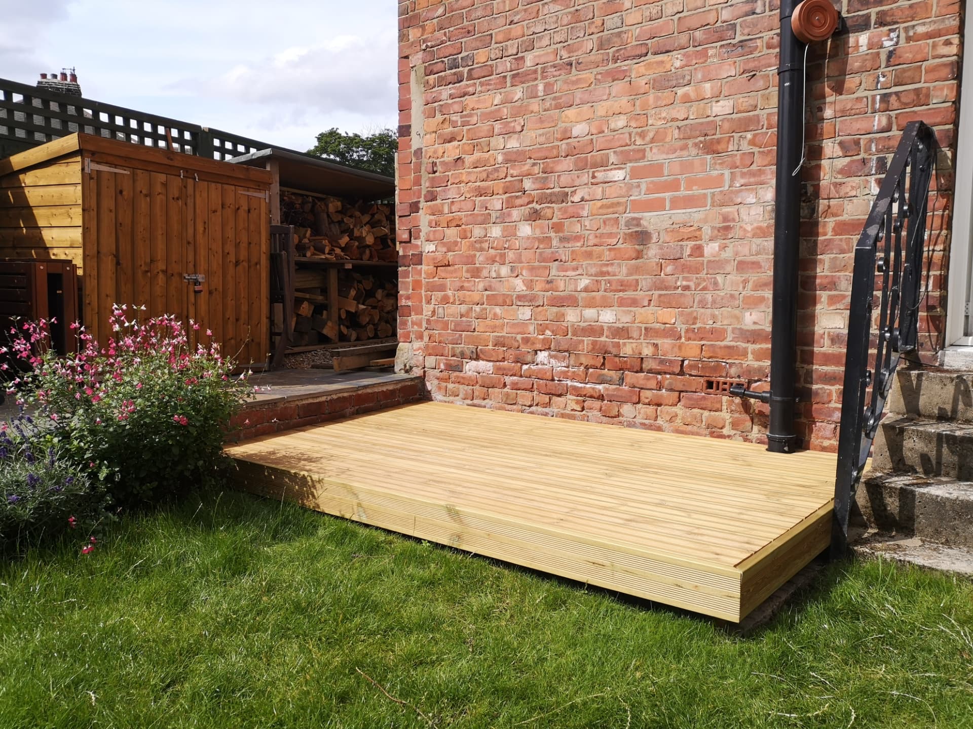 Garden decking — finished boards fitted alongside the house